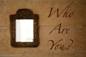 A photo of a mirror saying "Who are you?"